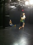 Molly demonstrating a scene for actors Lantie Tom and Luke Wise during rehearsal.